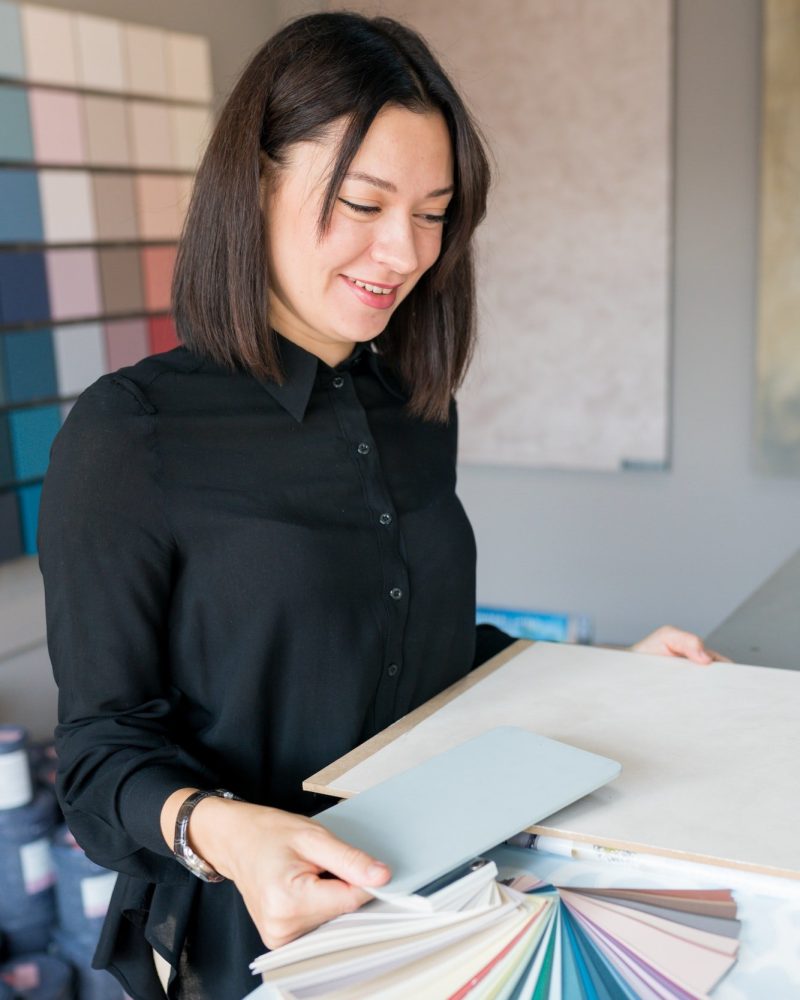 woman-choosing-materials-for-home-renovation-interior-designer-looking-at-color-samples-for-wall.jpg